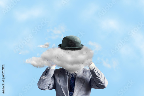 Businessman in a hat, with a cloud instead of a head, with arms raised. The concept of tough decision making, creative thinking, creativity, business. photo