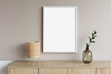 Blank picture frame mockup on gray wall. White living room design. View of modern scandinavian style interior with artwork mock up on wall. Home staging and minimalism concept