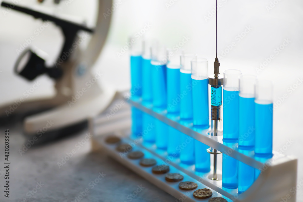 Vaccine vial search concept on table. Close up Vaccine flaskl for prevention,immunization and treatment. Vaccine vial search concept on table. Close up Vaccine flaskl for prevention,immunization and treatment.