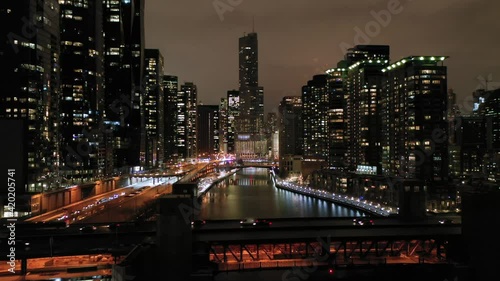 Urban Cityscape of Chicago City and Chicago River at Night in Winter. New Eastside and Streeterville. Aerial View. United States of America. Drone Flies Upwards photo