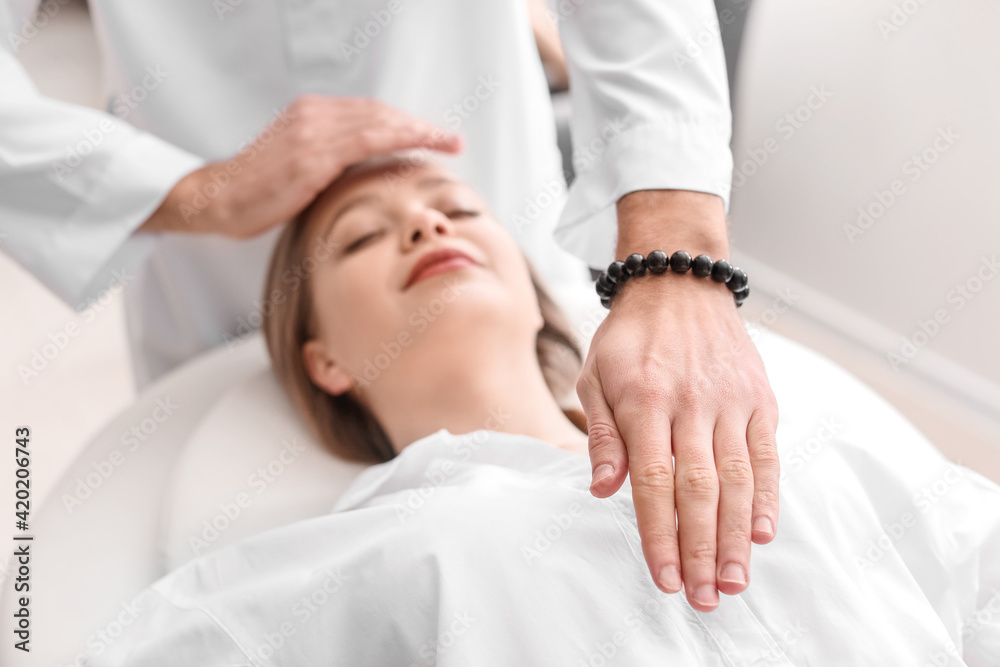 Reiki master working with patient Reiki master working with patient