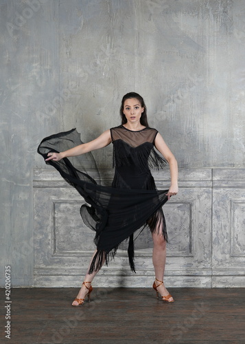 Woman dancer in motion with a cloth against the wall