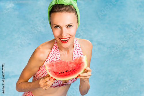 Canvas Print shot of attractive sexy woman in swimming suit posing in pool with watermelon