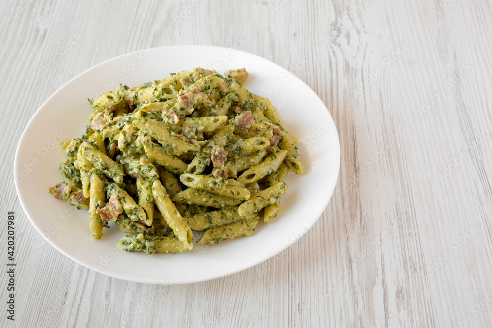 Homemade One-Pot Chicken Spinach Bacon Alfredo Pasta Ready to Eat, side view. Space for text. Homemade One-Pot Chicken Spinach Bacon Alfredo Pasta Ready to Eat, side view. Space for text.