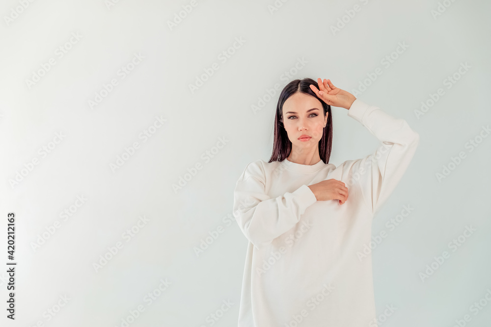 Mock-Up. portrait of a beautiful girl with black long hair in a hoody on a white background. the concept of sport Mock-Up. portrait of a beautiful girl with black long hair in a hoody on a white background. the concept of sport