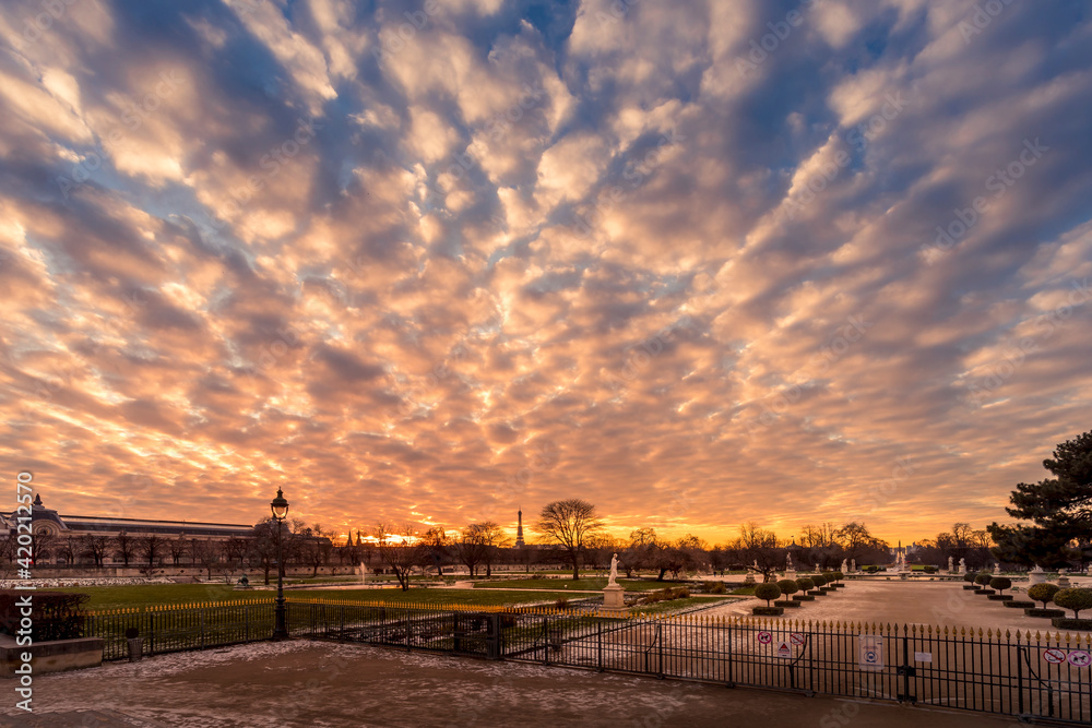Paris, France - February 12, 2021: Tuileries Garden in Paris covered with snow at beautiful sunset