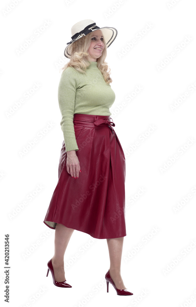 smiling woman in a summer hat striding forward smiling woman in a summer hat striding forward
