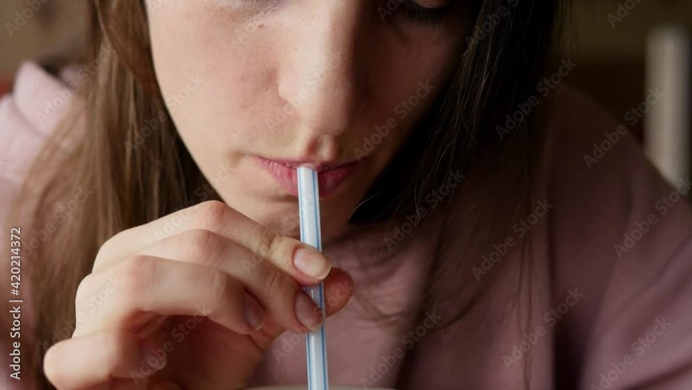 Young cute girl drinks a drink from a straw. Young cute girl drinks a drink from a straw.