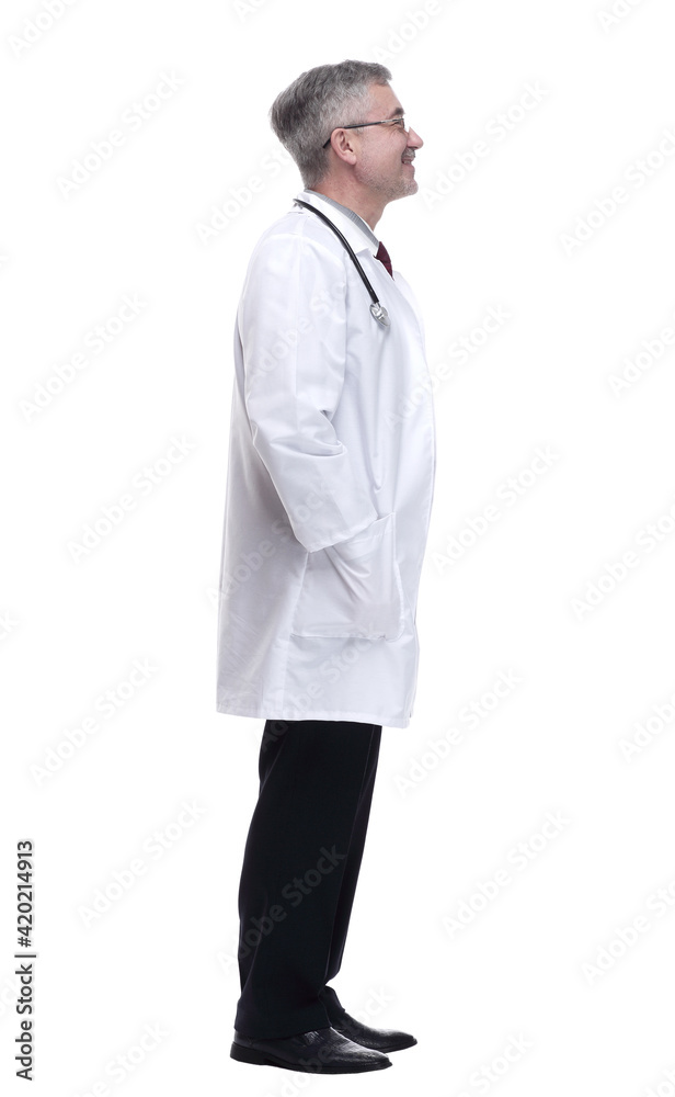 side view. a smiling doctor reading an ad on a white wall side view. a smiling doctor reading an ad on a white wall