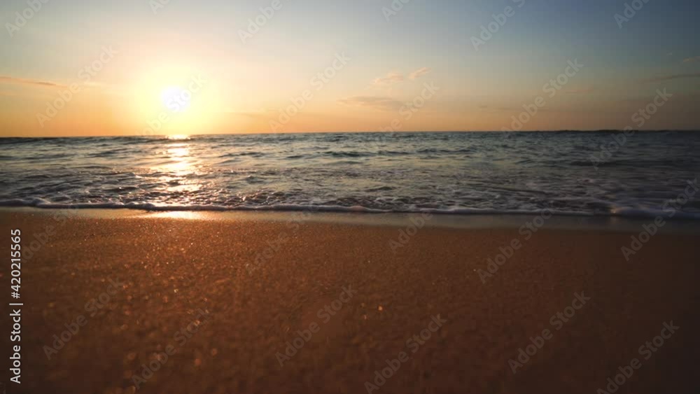 Ocean waves splashing on the sand, tropical beach during sunrise, 4k video Ocean waves splashing on the sand, tropical beach during sunrise, 4k video
