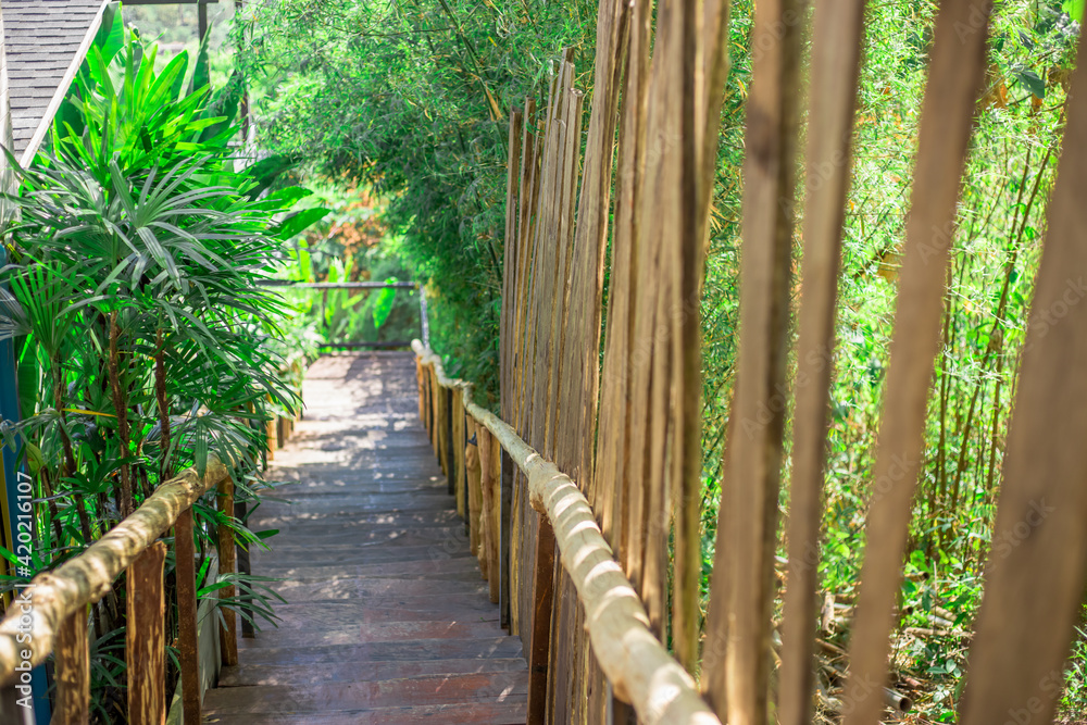 A blurry abstract view of a walkway or a treadmill on the condo and a small garden surrounded, allowing guests to exercise or view the garden in the evening