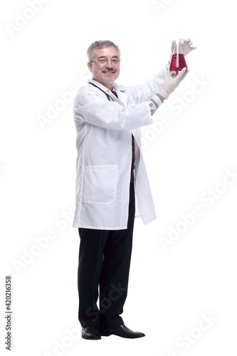 smiling doctor looking at the liquid in the flask