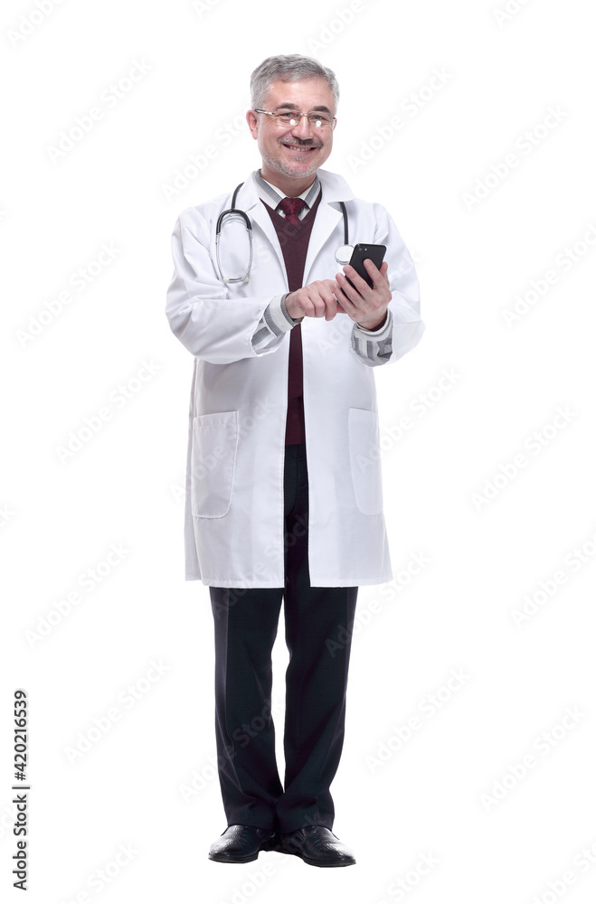 smiling doctor with a smartphone. isolated on a white smiling doctor with a smartphone. isolated on a white