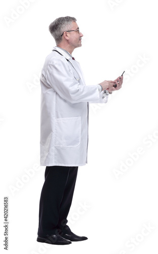 smiling doctor with smartphone looking forward. isolated on a white