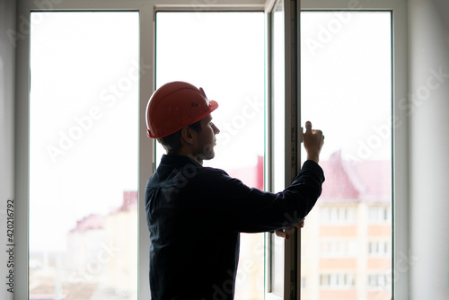 professional handyman worker install and adjust window in the house