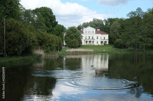 Raczynski Palace surrounded by a park with pond in the village of Zloty Potok in Krakowsko-Czestochowska Upland, Silesia, Poland photo