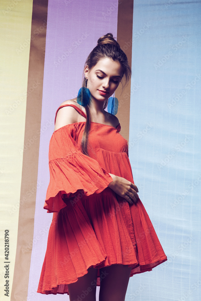 Woman in orange dress spinning on multi background Woman in orange dress spinning on multi background