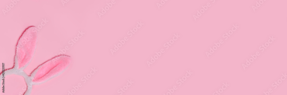 Funny Easter bunny ears on pink background. Top view. Copy space for text.Banner.Happy Easter, Funny Easter bunny ears on pink background. Top view. Copy space for text.Banner.Happy Easter,