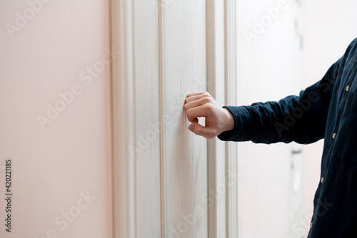 person hand knock the door, visit the friends house