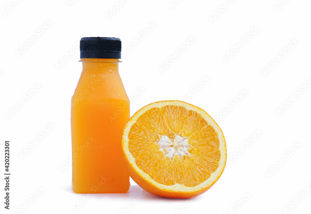 A bottle full of orange juice and a half-cut citrus leaning against the orange juice bottle on a white background. A bottle full of orange juice and a half-cut citrus leaning against the orange juice bottle on a white background.