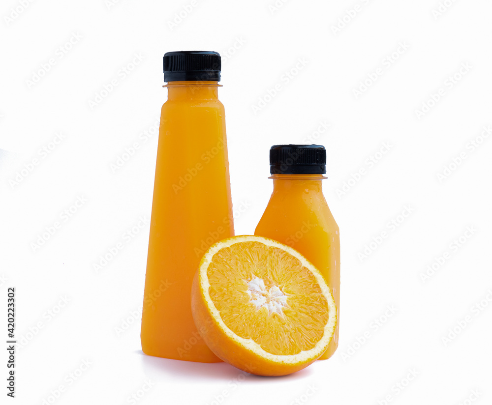 A bottle full of orange juice and a half-cut citrus leaning against the orange juice bottle on a white background. A bottle full of orange juice and a half-cut citrus leaning against the orange juice bottle on a white background.