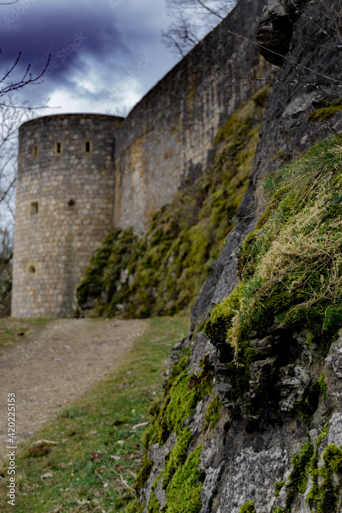 View on old castle wall under dark clouds 