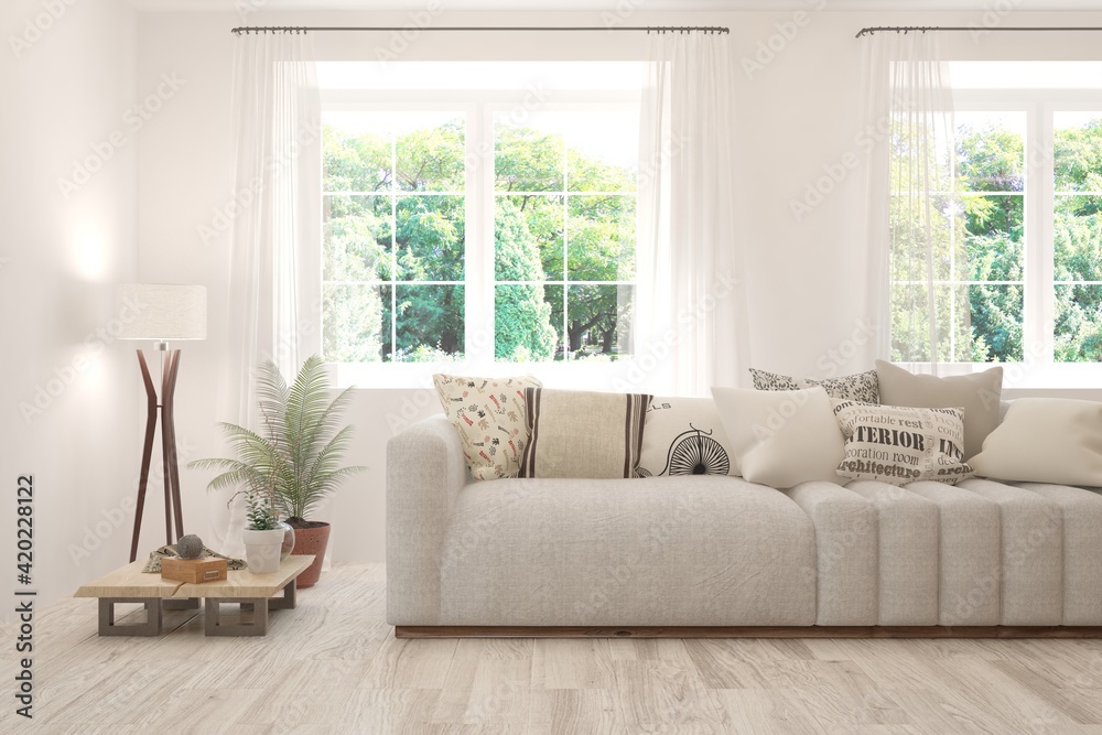 Fototapeta premium White living room with sofa and summer landscape in window. Scandinavian interior design. 3D illustration