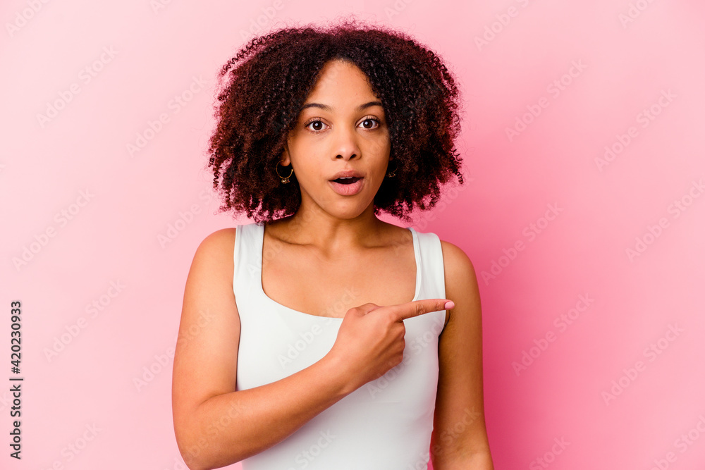 Young african american mixed race woman isolated pointing to the side Young african american mixed race woman isolated pointing to the side
