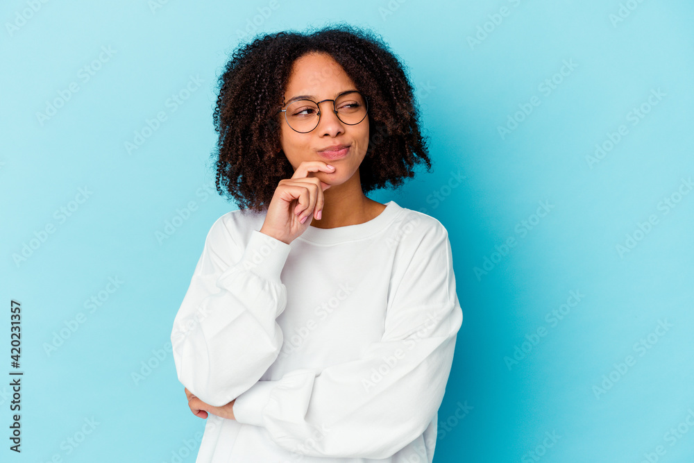 Young african american mixed race woman isolated holding a copy space on a palm.
