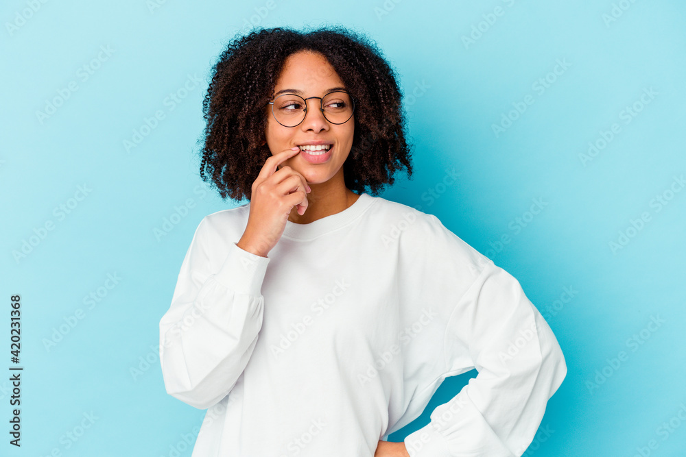Young african american mixed race woman isolated shouting very angry, rage concept, frustrated.