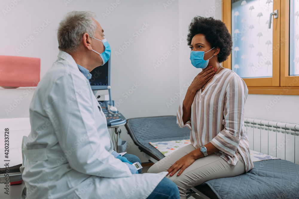 Patient explaining her symptoms to the doctor Patient explaining her symptoms to the doctor