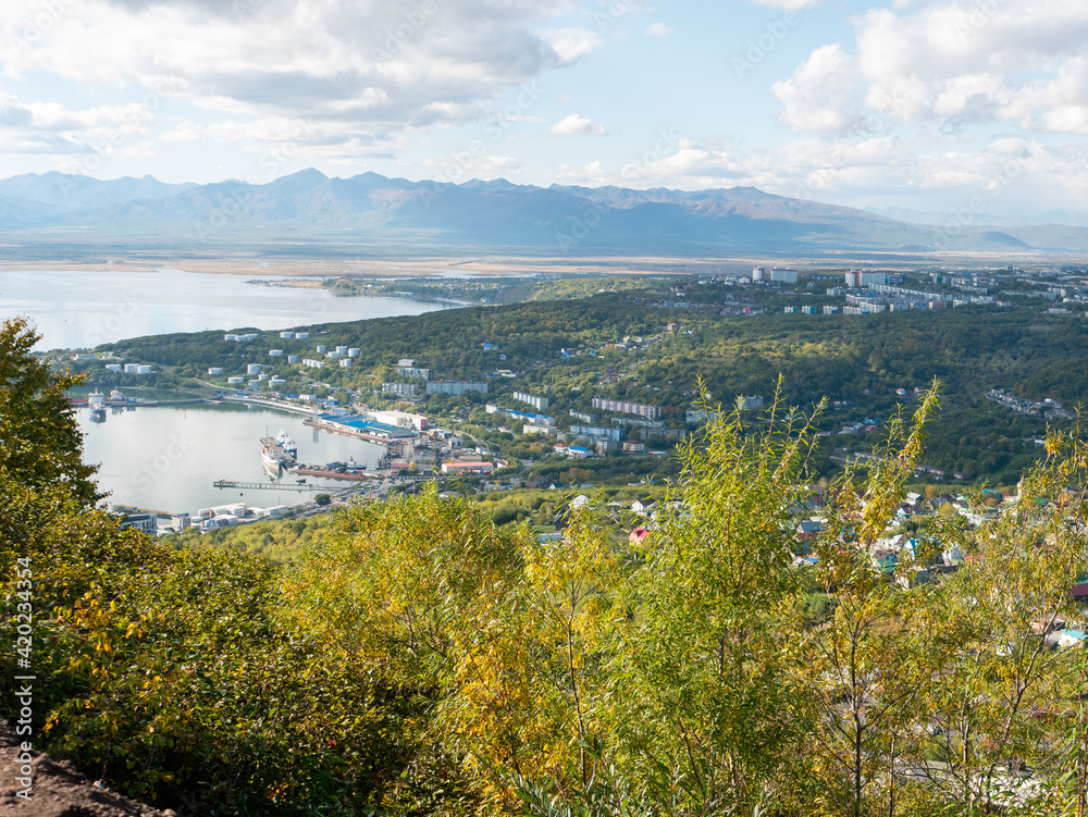 View of the city of Petropavlovsk-Kamchatsky and the sea bay from Mishennaya Sopka. Magnificent aerial view of the city and volcanoes. Kamchatka Peninsula, Russia.