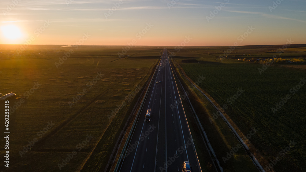 Fototapeta premium Drone image of a highway on a sunset