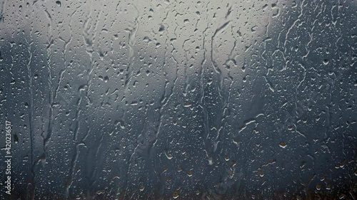 heavy rain falling on window surface
