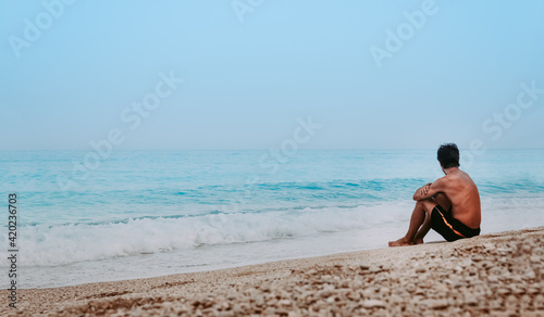 Young man chilling on the beach 