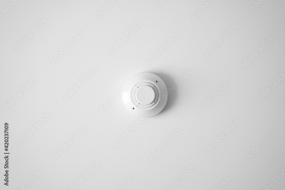 smoke detector sensor by fire alarm system for protect and detection object or safety equipment in smart home and building on white ceiling or wall with space smoke detector sensor by fire alarm system for protect and detection object or safety equipment in smart home and building on white ceiling or wall with space