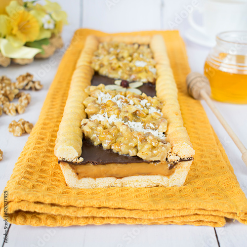 Chocolate-butterscotch mazurek with nuts in honey. Traditional Polish cake with a crispy base, baked on the occasion of Easter.