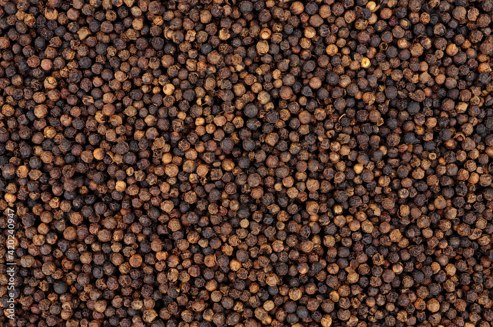 Whole dried black peppercorn spice seasoning background Whole dried black peppercorn spice seasoning background