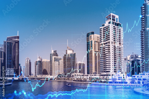 Skyscrapers of Dubai business downtown. International hub of trading and financial services of Western Asia. FOREX graph and chart concept. Double exposure. Dubai Canal waterfront.