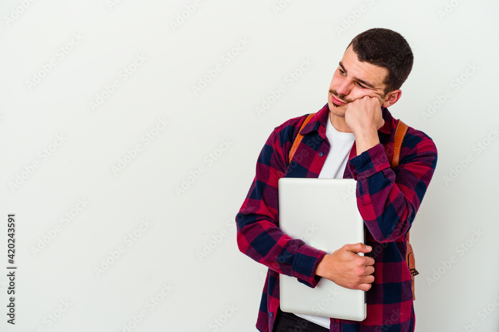 Young caucasian student man holding a laptop isolated on white background who feels sad and pensive, looking at copy space. Young caucasian student man holding a laptop isolated on white background who feels sad and pensive, looking at copy space.