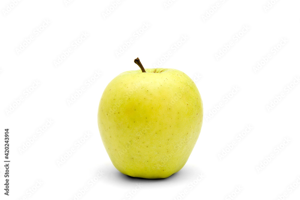 One whole golden delicious apple isolated on a white background