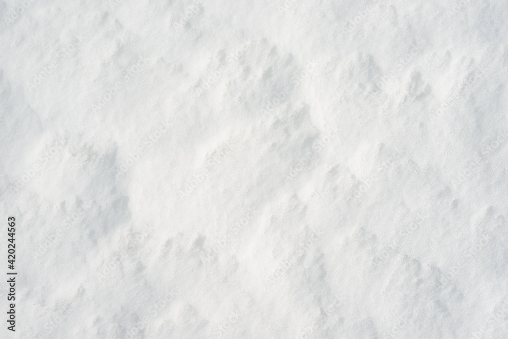 Fototapeta premium Fresh clean white snow background texture. Winter background with frozen snowflakes and snow mounds. Snow lumps. Seasonal landscape details. Cold weather.