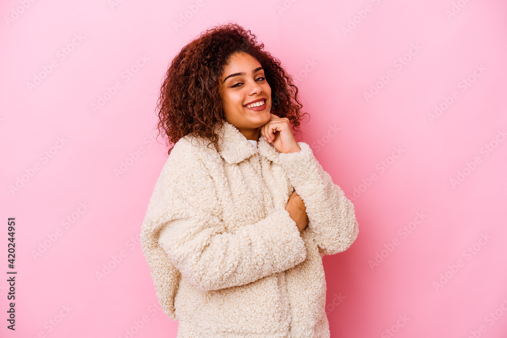 Young african american woman isolated on pink background smiling happy and confident, touching chin with hand. Young african american woman isolated on pink background smiling happy and confident, touching chin with hand.