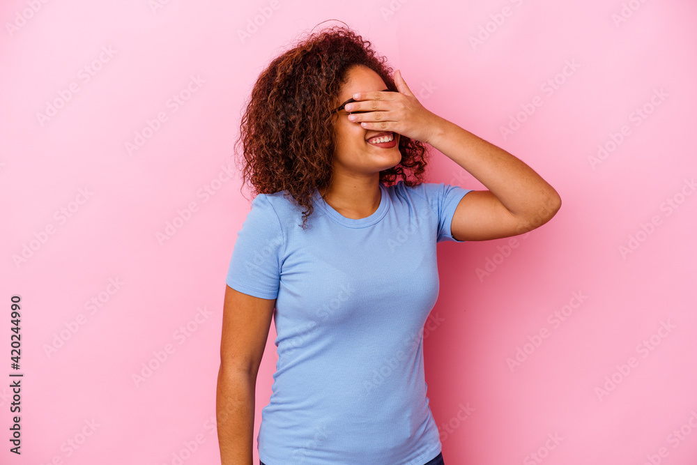 Young african american woman isolated on pink background laughs joyfully keeping hands on head. Happiness concept. Young african american woman isolated on pink background laughs joyfully keeping hands on head. Happiness concept.