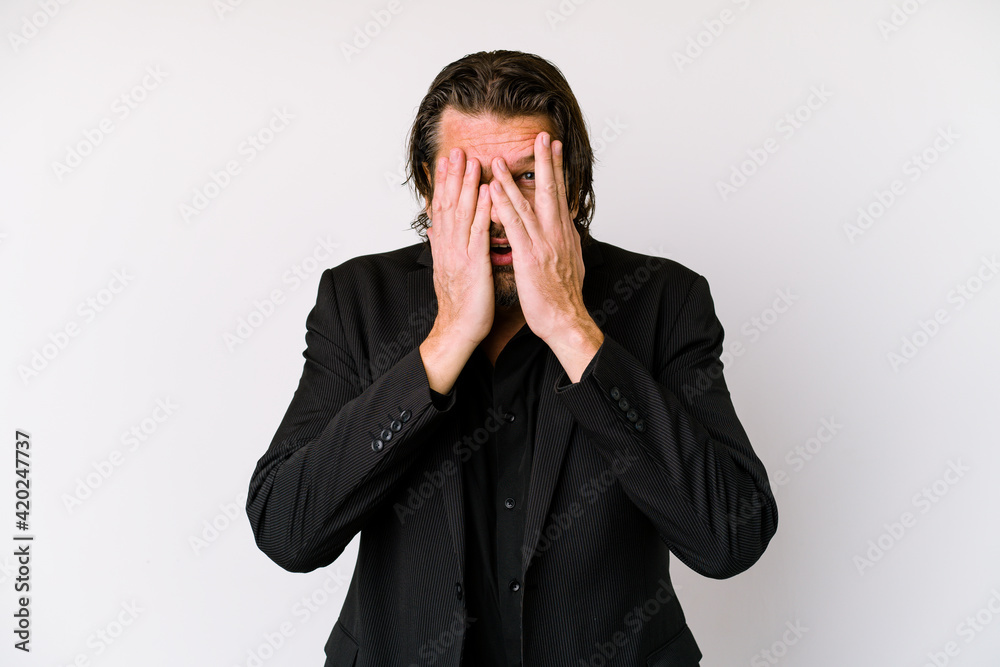 Middle age business dutch man isolated on white background blink through fingers frightened and nervous. Middle age business dutch man isolated on white background blink through fingers frightened and nervous.