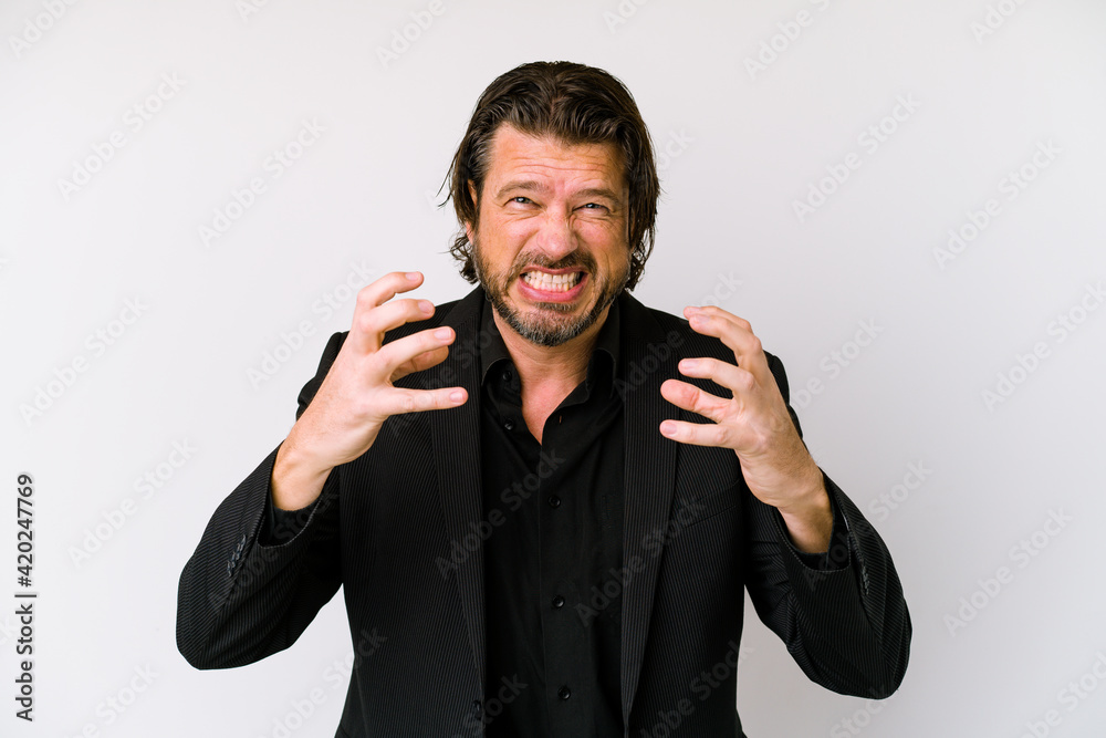 Middle age business dutch man isolated on white background upset screaming with tense hands. Middle age business dutch man isolated on white background upset screaming with tense hands.