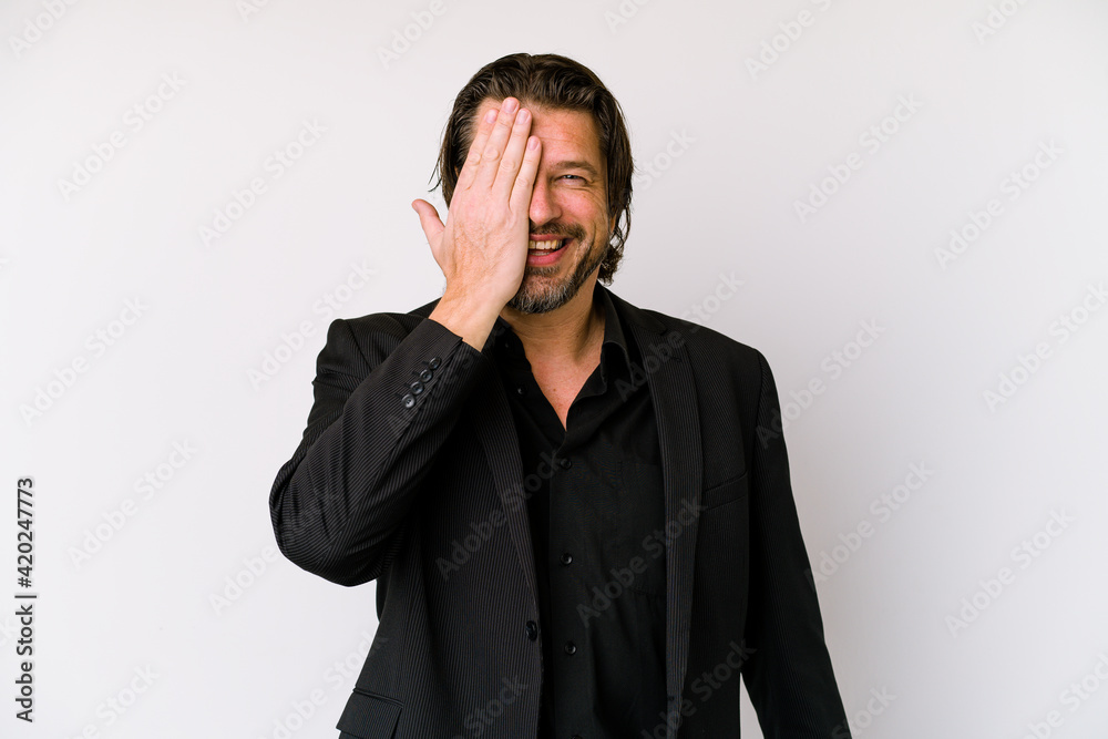Middle age business dutch man isolated on white background having fun covering half of face with palm. Middle age business dutch man isolated on white background having fun covering half of face with palm.