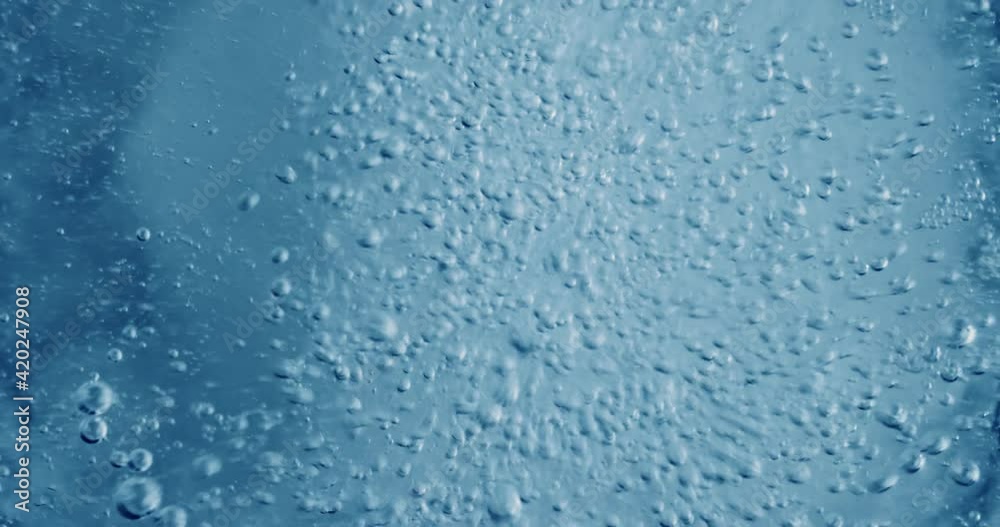 Oxygen bubbles in water on a blue abstract background Oxygen bubbles in water on a blue abstract background