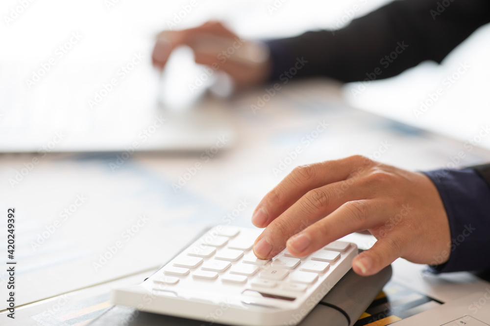Businessmen are calculating income-expenditure and analyzing real estate investment data, Accounting Financial and tax systems concept. Businessmen are calculating income-expenditure and analyzing real estate investment data, Accounting Financial and tax systems concept.