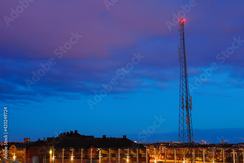 Photography Stockholm, Sweden A mobile phone antenna at night over the city.